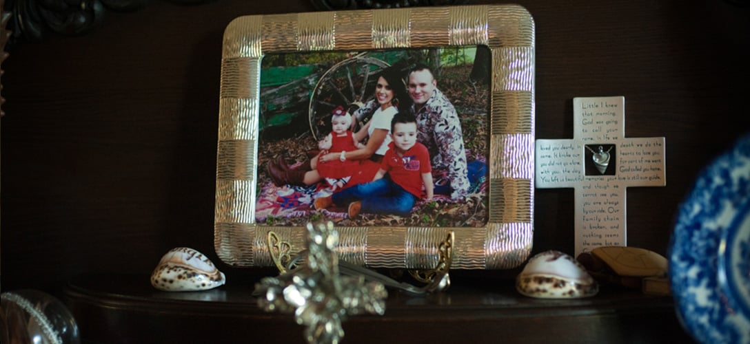 A photograph of the late Wayne Davis; his wife, Crystal Davis; and their two children, Cash and Lucy, on a table at his parents' home in Tyler. Photo by Brandon Thibodeaux.