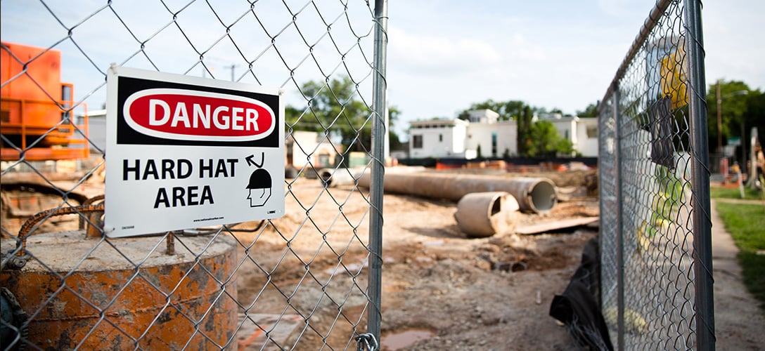 A sign at a construction area in Austin warns workers to wear protective gear. Photo by Callie Richmond.