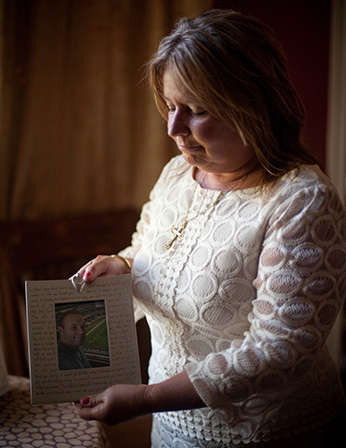 Lynne Davis displays a photograph of her son. Photo by Brandon Thibodeaux.