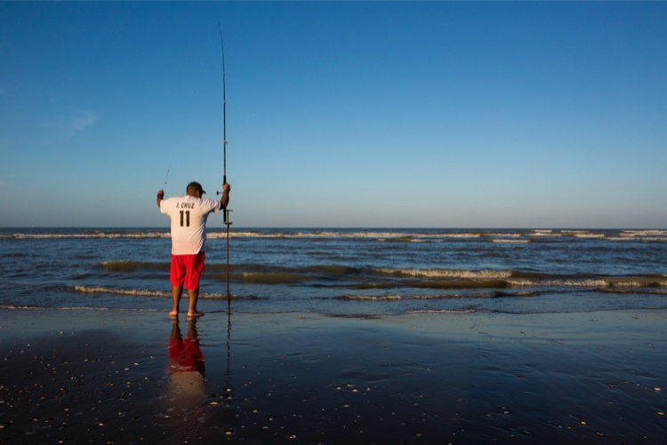 Adrian Cruz fishes a mile south of the proposed SpaceX launch site on Boca Chica Beach.